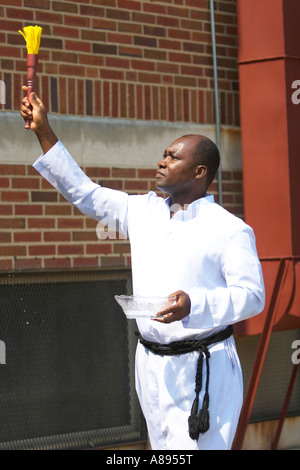 Priest Sprinkling Holy Water while giving a blessing Stock Photo