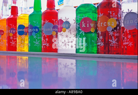 different colored bottles of flavoured drink syrup Stock Photo