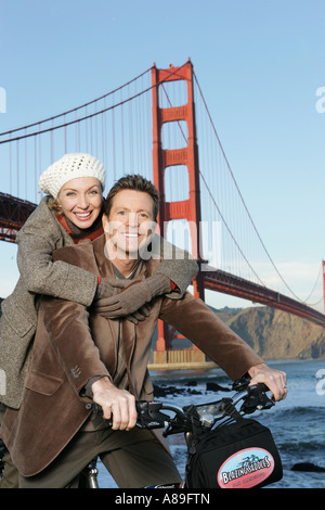 Mature couple smiling at camera on bikes Stock Photo