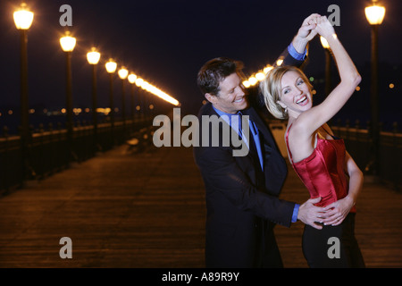 Mature couple dancing outdoors Stock Photo