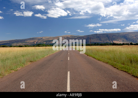 A seconary road and the Magaliesberg mountains in South Africa's North West Province. Stock Photo