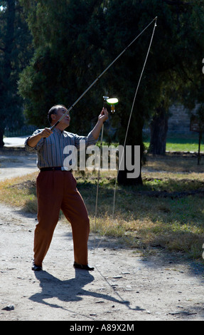 CHINA BEIJING Elderly Chinese man whirling and balancing a diabolo or devil on two sticks a type of Chinese yoyo Stock Photo
