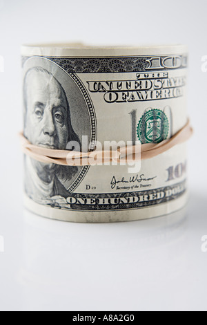 Roll of hundred dollar bills Stock Photo