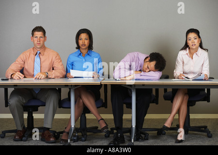 Businessman sleeping during a meeting Stock Photo