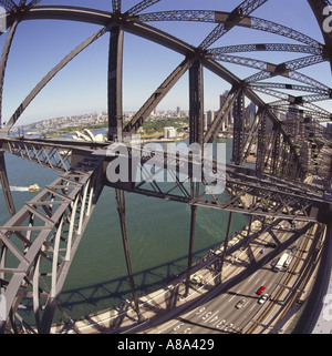 View from within the metal girder superstructure of Sydney Harbour Bridge with Bennelong Point Opera House Sydney Australia Stock Photo