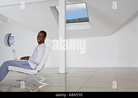 Relaxed man using laptop Stock Photo