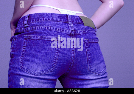 woman in open jeans undressing showing purple panties Stock Photo