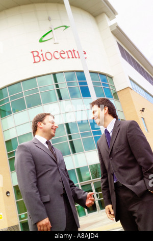 Two businessmen talking outside BioCentre building at York Science Park Heslington York Stock Photo