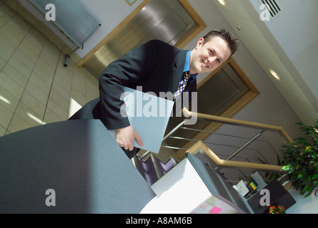 One Businessman with folder of notes at reception desk of IT Centre Building York Science Park Heslington York UK Stock Photo