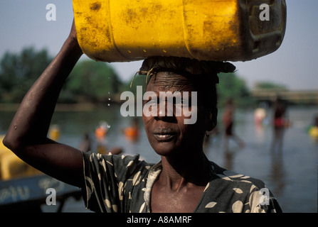 Woman collecting water from the Baro river , Gambella , Ethiopia Stock Photo