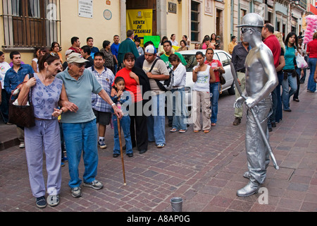 PIERRE and CHRISTINE KOLISCH watch a performance during the CERVANTINO FESTIVAL GUANAJUATO MEXICO MR Stock Photo