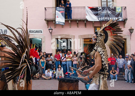 An AZTEC DANCE TROUPE performs in traditional feathered COSTUMES at the CERVANTINO FESTIVAL GUANAJUATO MEXICO Stock Photo