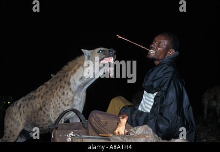 The Hyena man feeding wild hyenas at night outside the city wall, Harar, Ethiopia Stock Photo