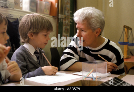 Teacher working with younGBoy in a South London primary school Stock Photo