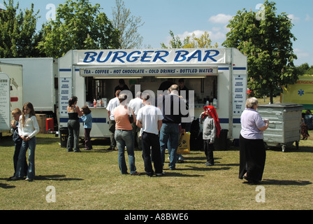 Dog show event people customer adults & children around & being served at mobile fast food Burger Bar counter mobile trailer facility Essex England UK Stock Photo