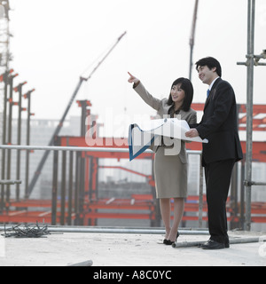 at a construction place architects discussing about a plan Stock Photo