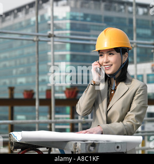 at a construction place an architect talking on the phone Stock Photo