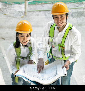 at a construction place architects discussing about a plan Stock Photo