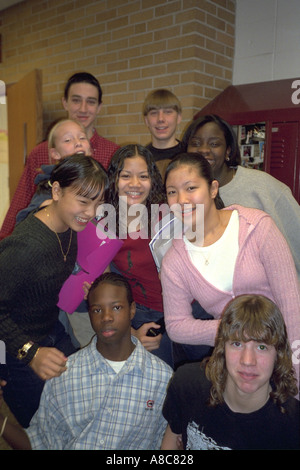 Group of students age 15 in front of school hallway lockers between class. Golden Valley Minnesota USA Stock Photo