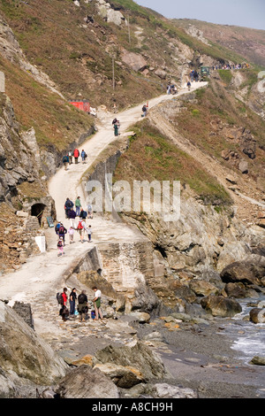 UK Lundy Island arriving visitors on road from landing beach to the village at high tide Stock Photo