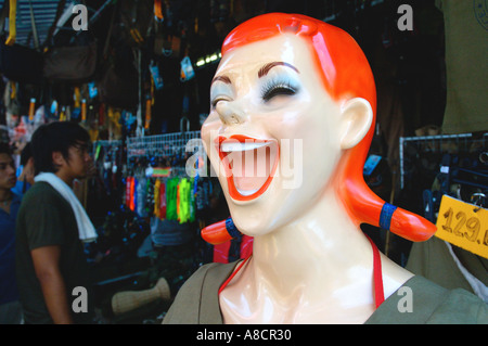 Thailand Bangkok Chatuchak Weekend Market Head of funny laughing female manequin in front of clothes shop Stock Photo