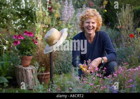 Happy laughing woman waters the plants Stock Photo: 241060545 - Alamy