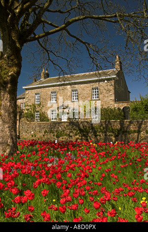 Newton Hall with red tulips/ Newton in Bowland / Lancashire / UK - a Grade II Georgian manor house Stock Photo