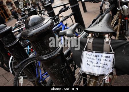 One bicycle left locked up in London s Leicester Square jokes about railings being removed if attached to bikes Stock Photo