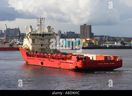 Offshore Supply Ship in Aberdeen Harbour with the City Centre beyond, Aberdeenshire, Scotland uk Stock Photo