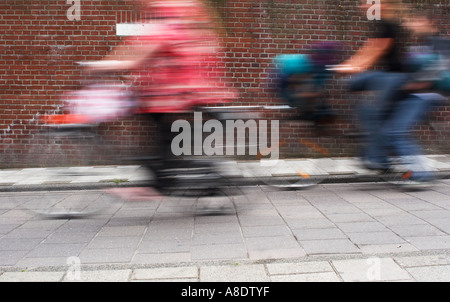 Cyclists Passing In Street Stock Photo