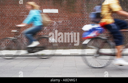 Cyclists Passing In Street Stock Photo