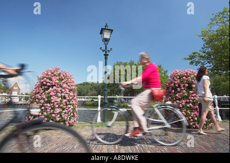 Cyclists Passing In Street Stock Photo