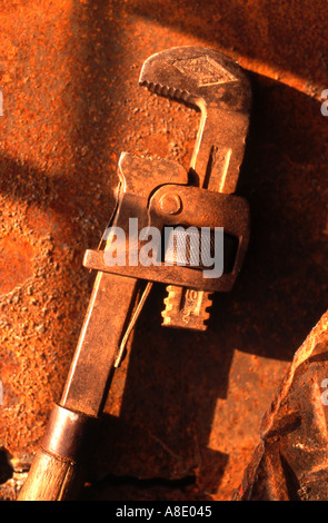 Pipe wrench lying on metal background Stock Photo
