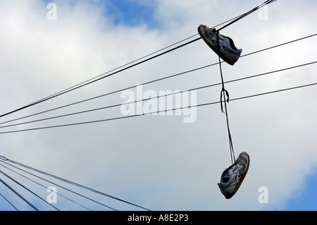 Shoes hanging from telephone wire Stock Photo