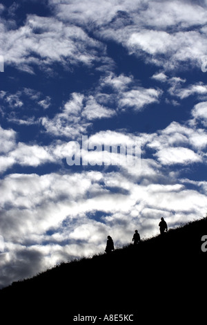 Three people hillwalking on a hill, Kinder Scout in the Peak District National Park,  Derbyshire, Near Sheffield, Stock Photo