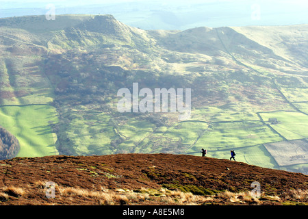 Two people hillwalking on a hill, Kinder Scout in the Peak District National Park, Derbyshire, Near Sheffield, Stock Photo