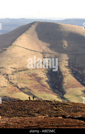 Three people hillwalking on a hill, Kinder Scout in the Peak District National Park,  Derbyshire, Near Sheffield, Stock Photo