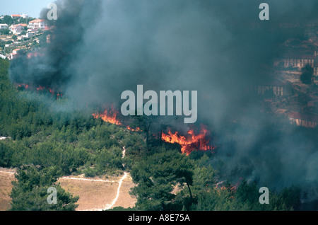 Aerial view of a wildfire, flames, forest fire black smoke, threatening town buildings, Bouches-du-Rhône, Provence, France, Europe, Stock Photo