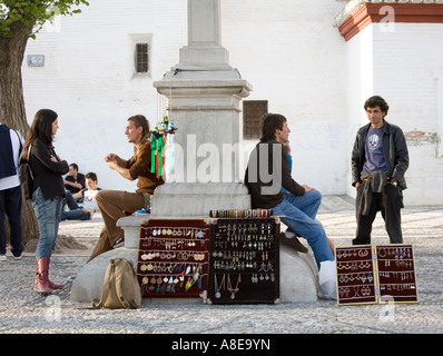 Travellers with gypsy hand made goods on sale at the Mirador de San Nicolas Granada Spain Stock Photo
