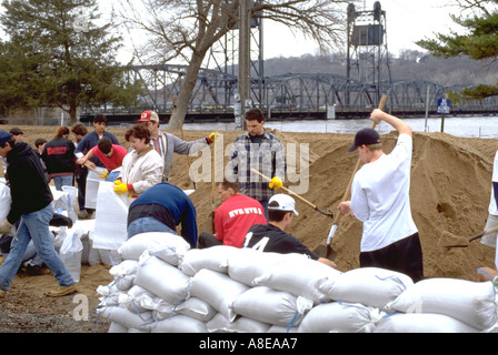Volunteers age 15 to 45 filling sandbags in St Croix River flood control. Stillwater Minnesota USA Stock Photo