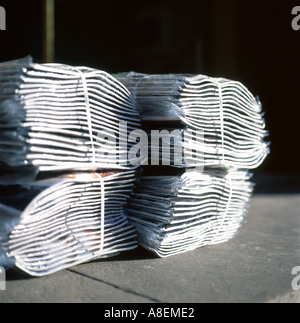 Bundles of newspapers and magazines waiting for delivery on pavement outside newsagent in Fleet Street London England UK Great Britain KATHY DEWITT Stock Photo