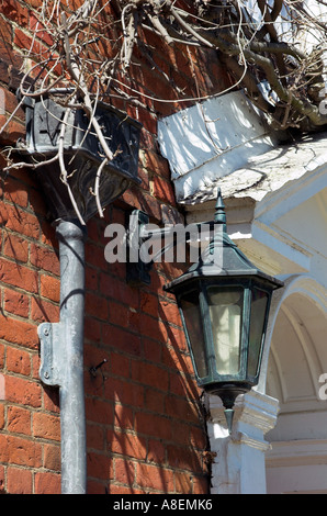 Detail of lead drain pipe and an old-fashioned lamp on the Bucklers Hard House Hotel,New Forest,Hampshire.England. Stock Photo