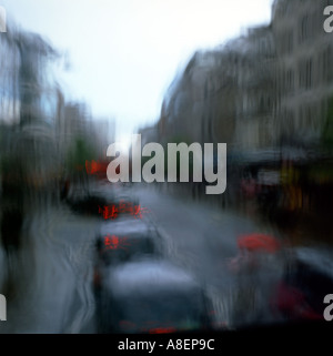 A view of a queue of black taxi cabs on Oxford Street looking out of a window on a rainy day in traffic London England UK Great Britain  KATHY DEWITT Stock Photo