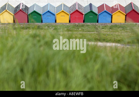 A row of multi coloured beach huts on the west beach Whitby North Yorkshire England hotton le hole north yorkshire england uk Stock Photo