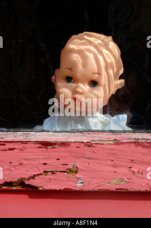 Doll Behind Glass Door Stock Photo