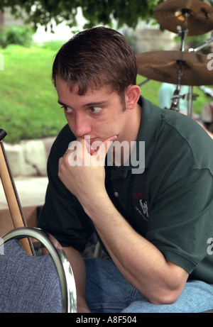 Teen age 16 resting after busy day at Grand Old Day Parade. St Paul Minnesota USA Stock Photo