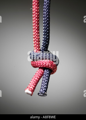 rope, twice, tied knot, blue, red, tough, close up, gray background, fabric, tighten, strings Stock Photo