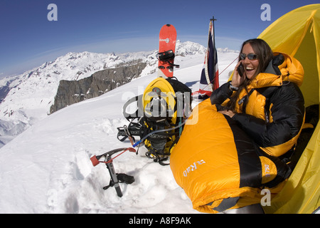 Women makes cell phone call on mountain peak Stock Photo