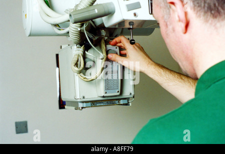 Radiographer positioning x ray equipment Stock Photo