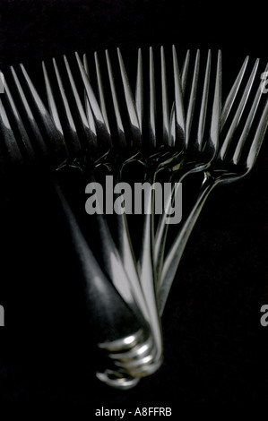 cutlery forks layed out against a black background Stock Photo